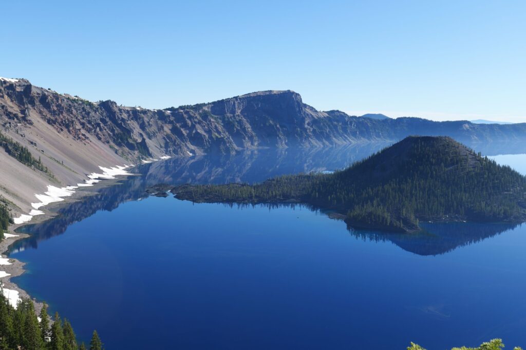 Aerial view of Crater Lake's deep blue water and surrounding caldera cliffs