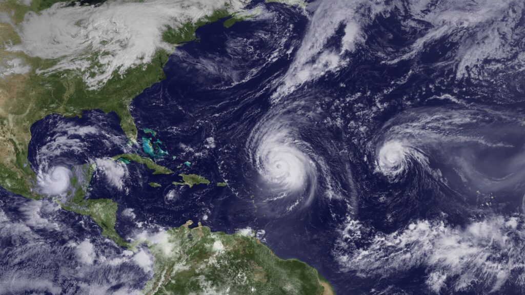 NOAA satellite image showing three tropical systems spinning in the Atlantic during hurricane season