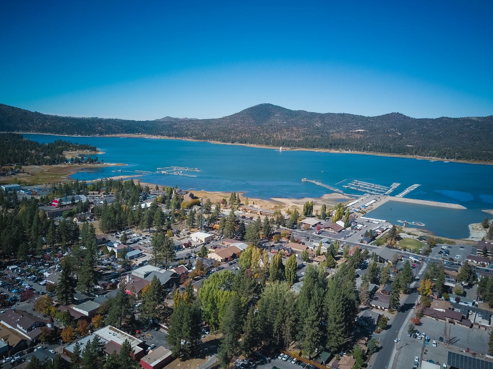 Aerial view of Big Bear Lake and the village surrounded by pine-covered mountains