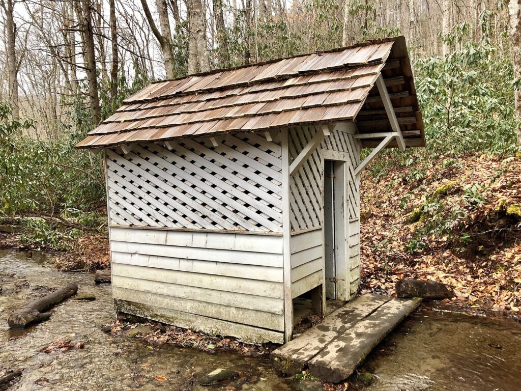 The Caldwell family's small wooden spring house built over a stream in Cataloochee Valley