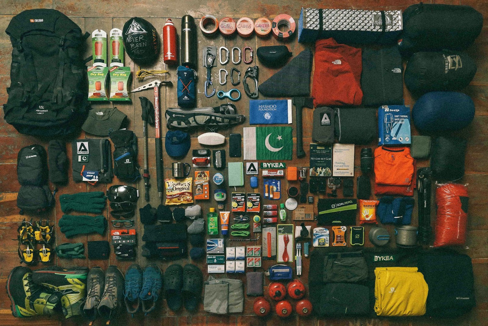 An assortment of camping gear laid out on a dark surface.