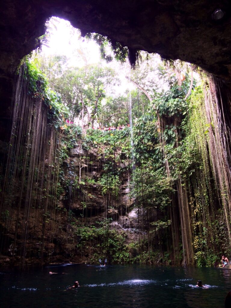Cenote Ik Kil, a round open-air sinkhole with hanging vines and turquoise water below
