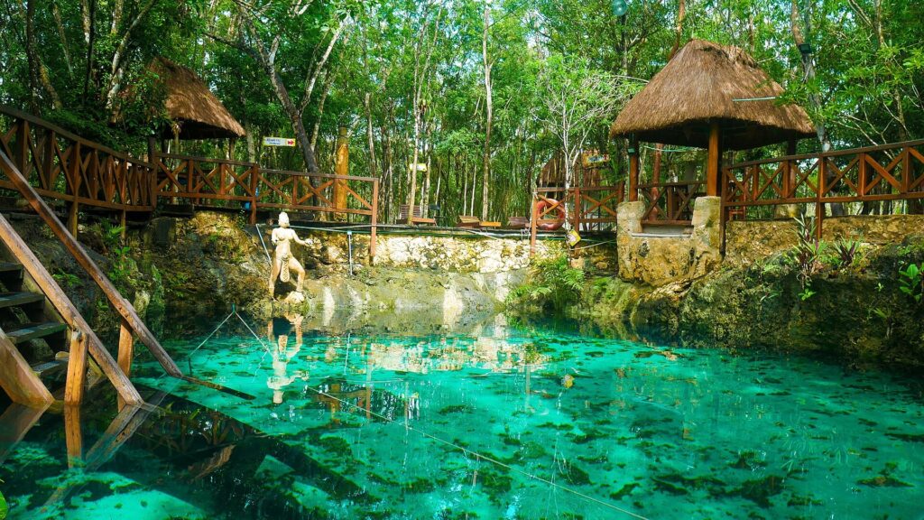 Cenote Zacil-Ha near Tulum, Mexico, with its wooden platform over clear blue water