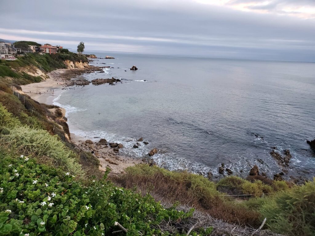 Calm cove and rocky shoreline seen from the bluff at Corona del Mar