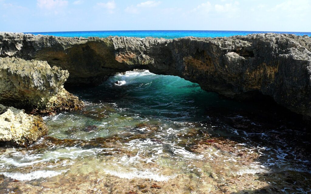 A rocky arch and surf on the windward reef of Cozumel, Mexico