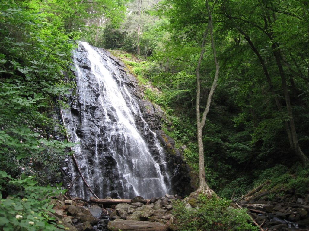 Crabtree Falls dropping over a rock face in a forest along the Blue Ridge Parkway