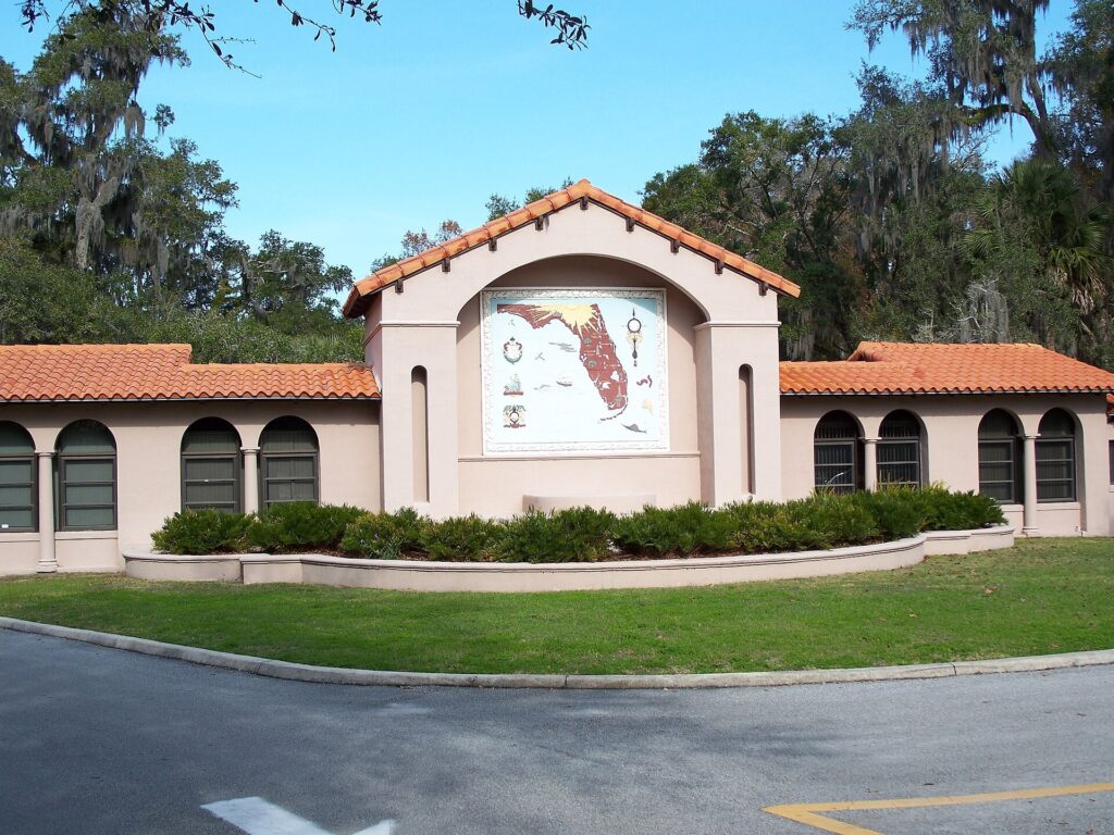 A Spanish Mission-style park building at De Leon Springs with a hand-painted map of Florida on the wall