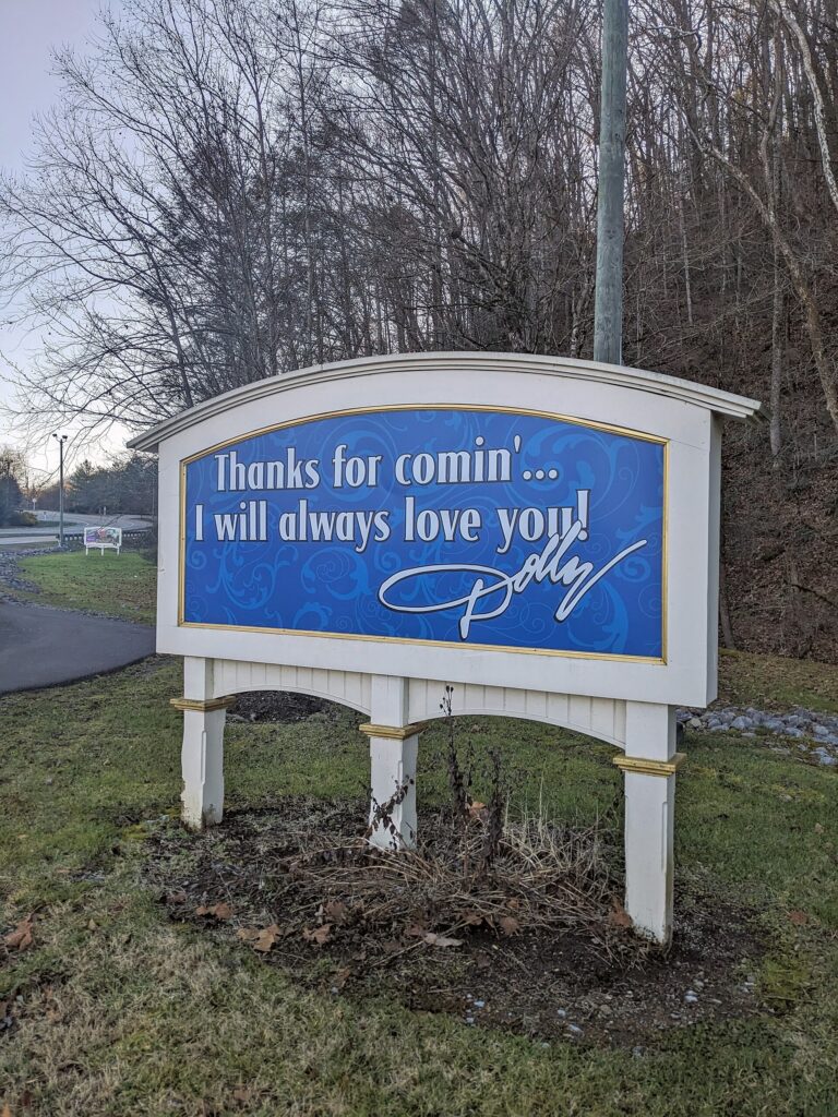 A sign at the entrance road to Dollywood in Pigeon Forge, Tennessee
