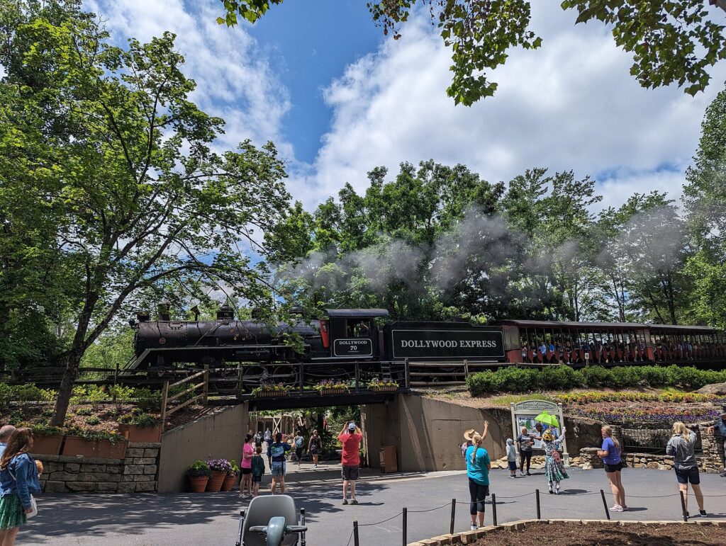 Dollywood Express steam train pulling passenger cars through the park