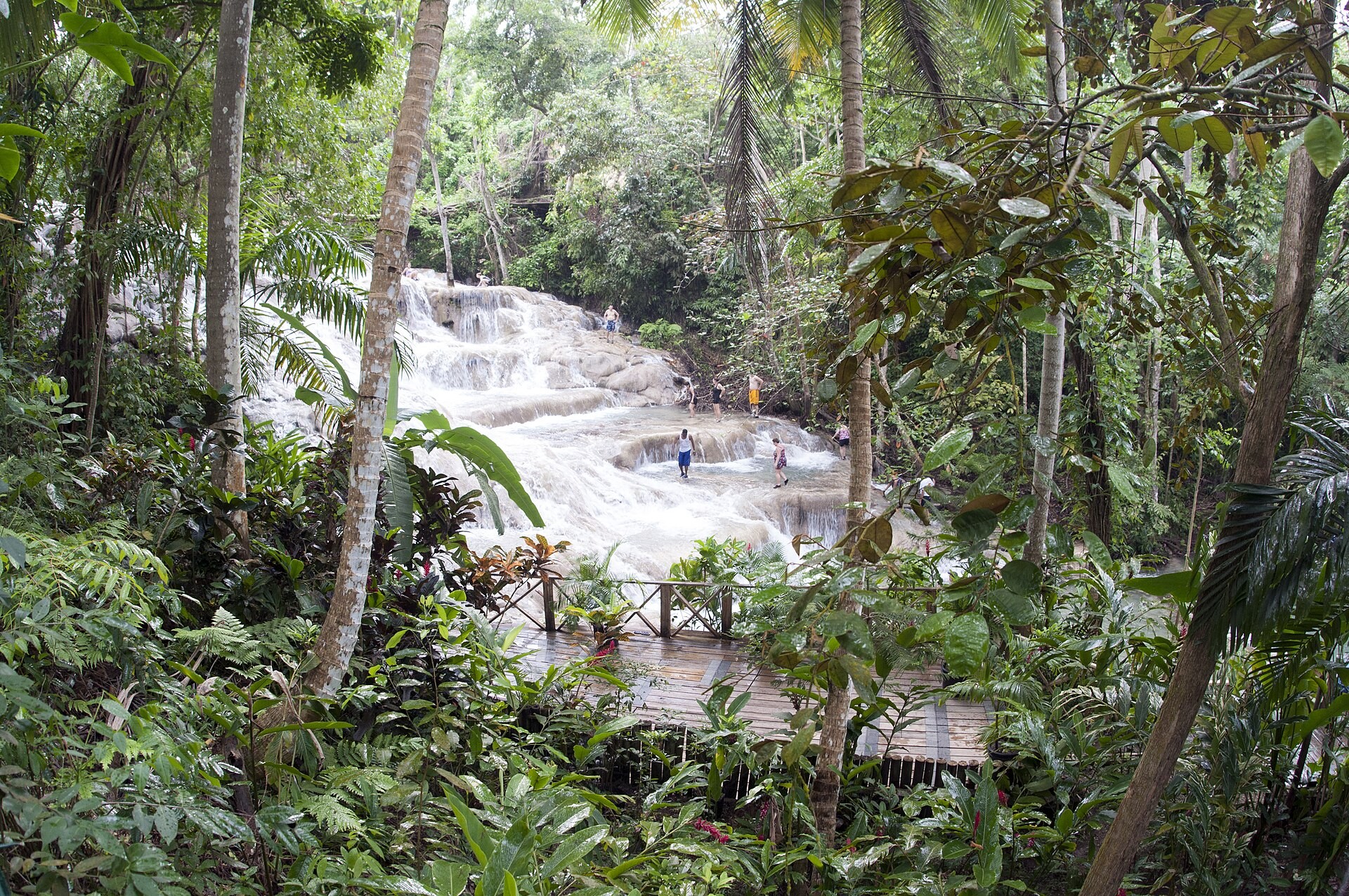 Wide view of Dunn's River Falls cascading over terraced limestone rock in Ocho Rios, Jamaica