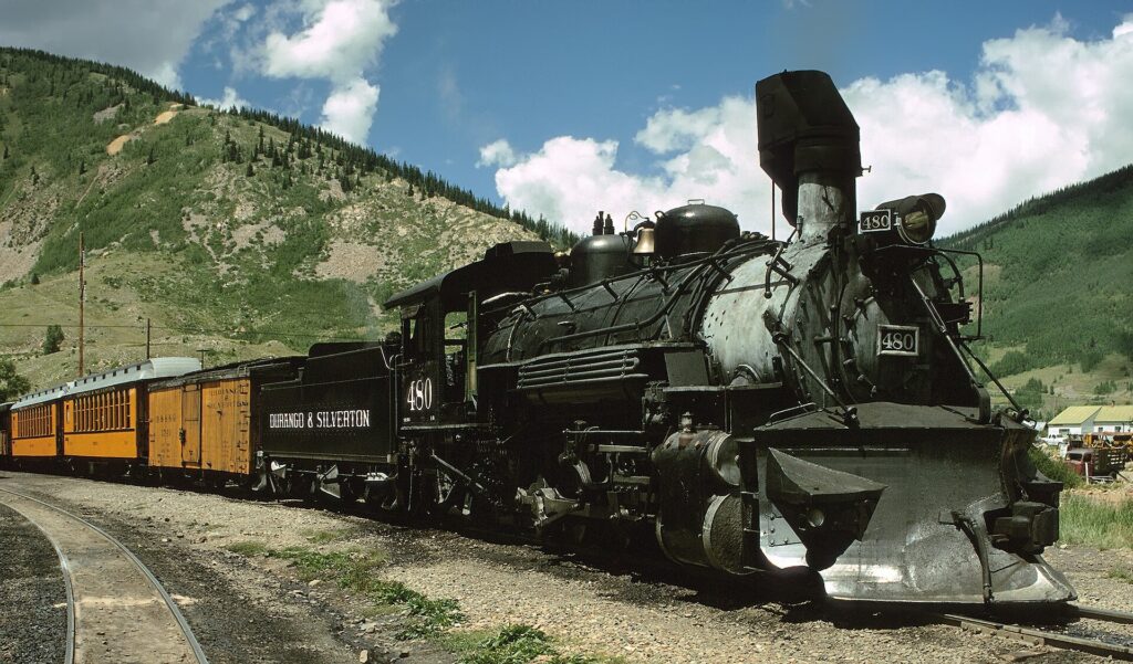 A steam train of the Durango and Silverton Narrow Gauge Railroad on the tracks in the San Juan Mountains