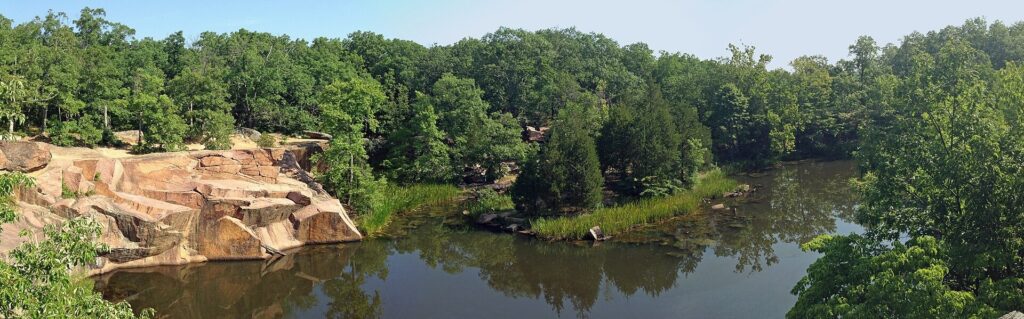 Water-filled former quarry pond surrounded by granite at Elephant Rocks State Park
