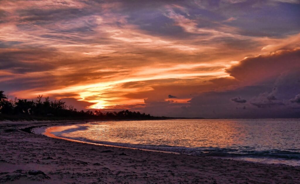 Sunset over the water on a beach in Eleuthera, Bahamas