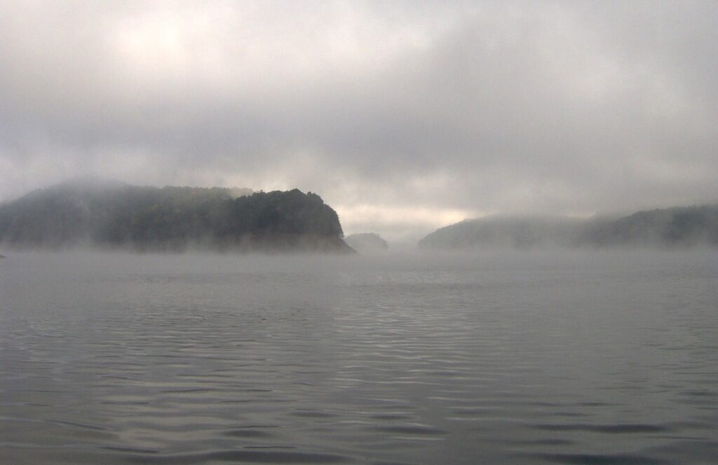 Fog lifting off the water of Fontana Lake on a fall morning