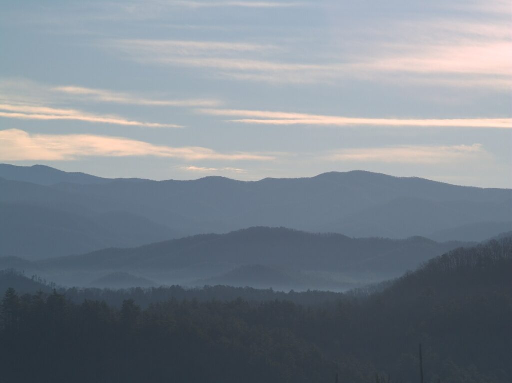 Layered mountain ridges fading into blue haze, seen from an overlook on Foothills Parkway