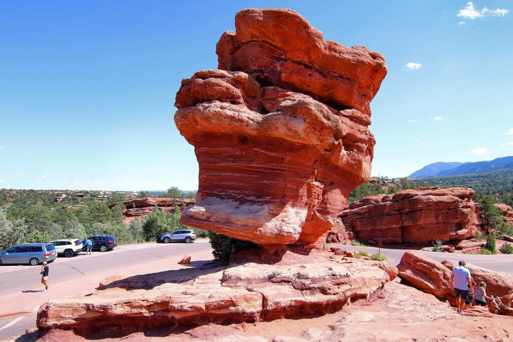 Balanced Rock, a large boulder perched on a narrow sandstone base, at Garden of the Gods