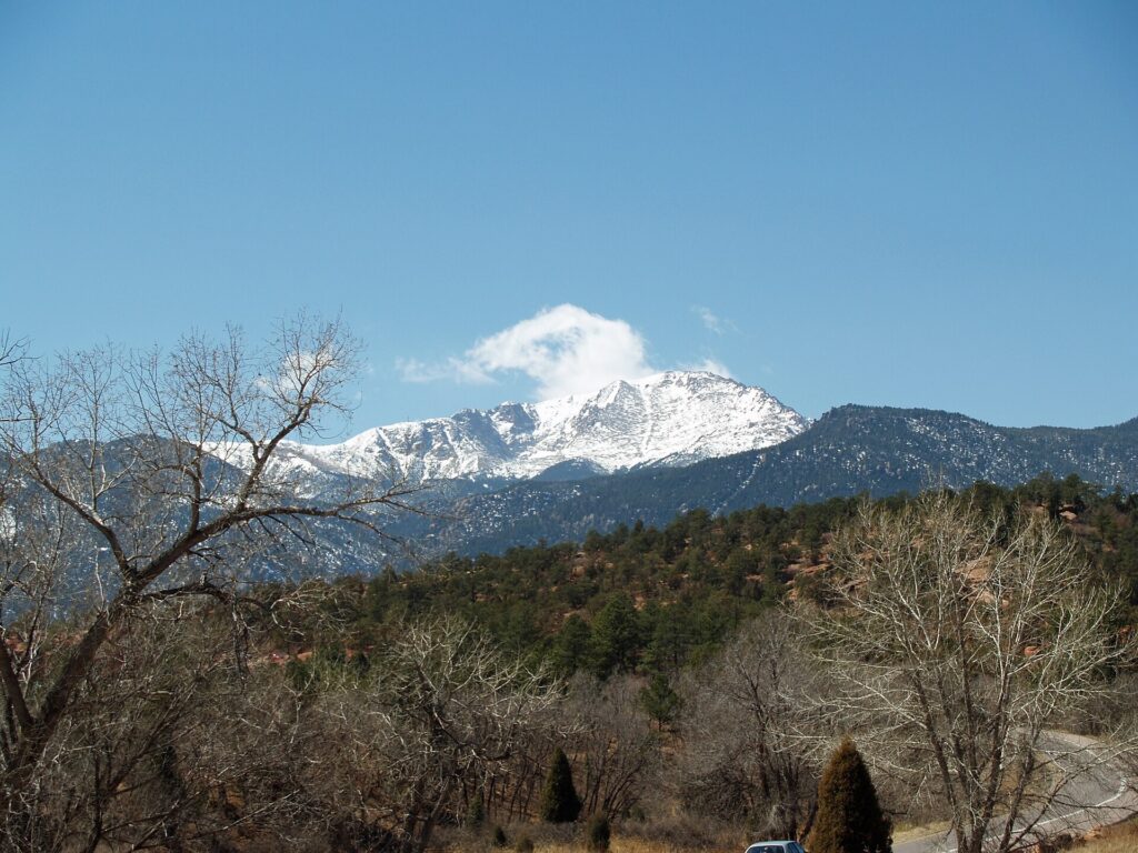 Pikes Peak rising behind the red rock formations of Garden of the Gods