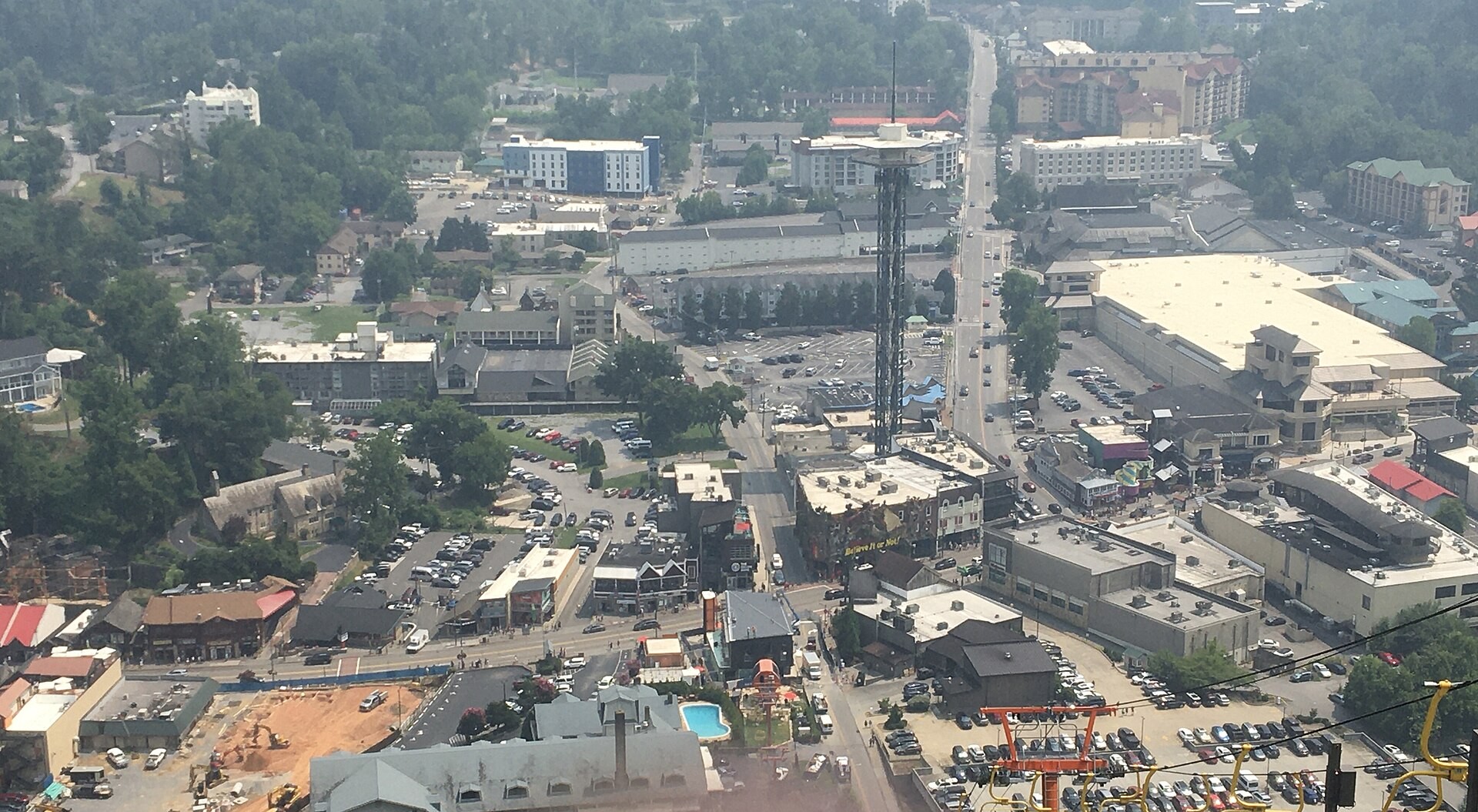 Aerial view of downtown Gatlinburg, Tennessee with the Parkway and surrounding mountains