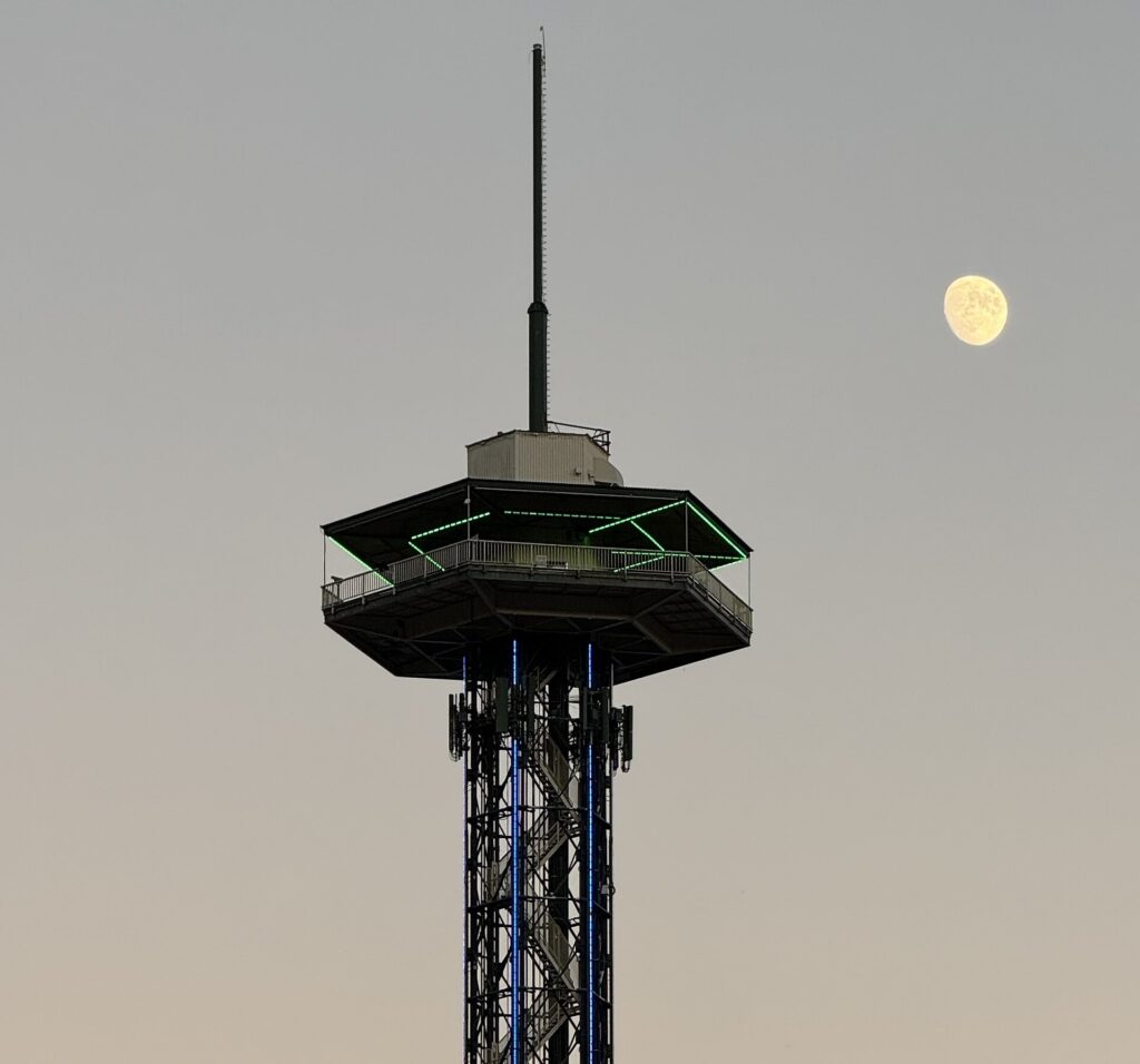 The Gatlinburg Space Needle observation tower against the evening sky with the moon