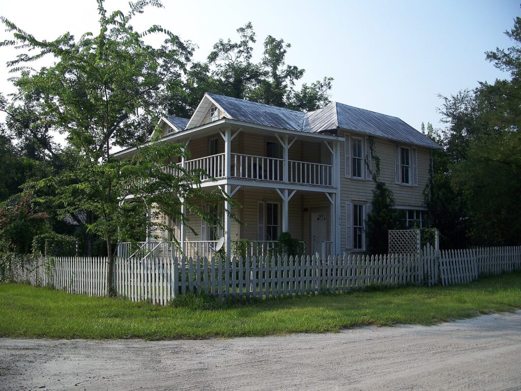 Historic wooden house with a wraparound porch in High Springs, Florida