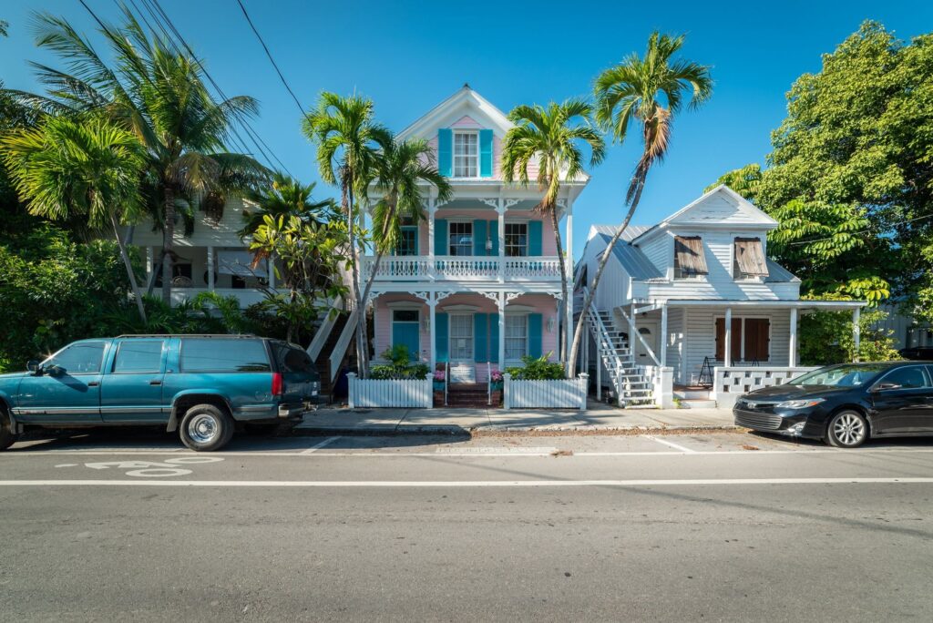 Painted historic wooden conch houses with gingerbread trim on a quiet Key West residential street