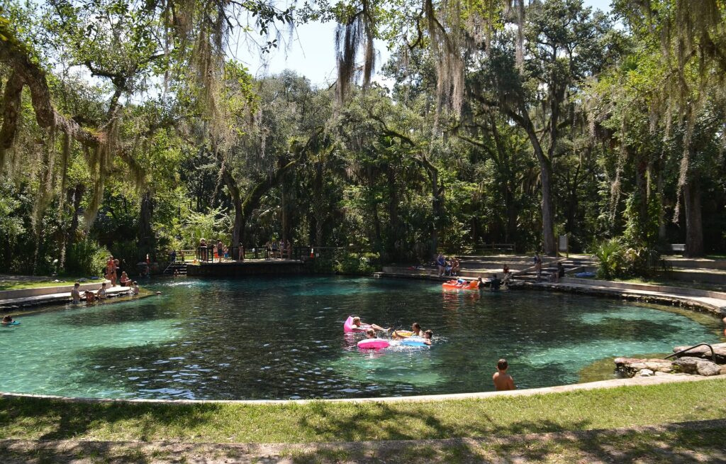 Swimmers and pool floats in the clear spring pool at Juniper Springs in Ocala National Forest