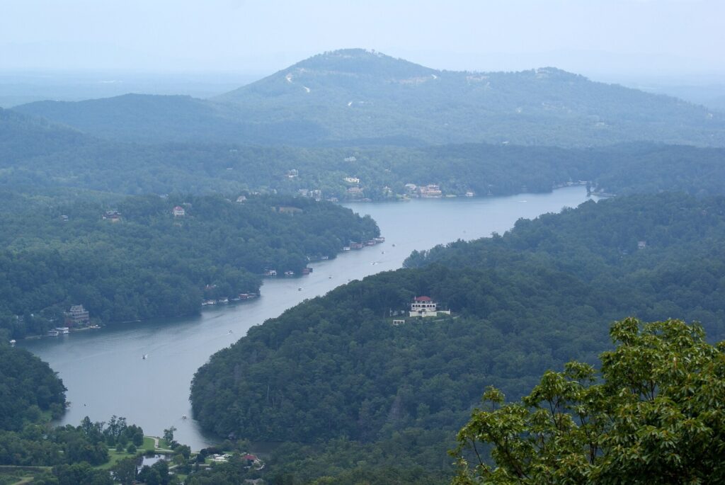 The blue water of Lake Lure surrounded by wooded hills in North Carolina