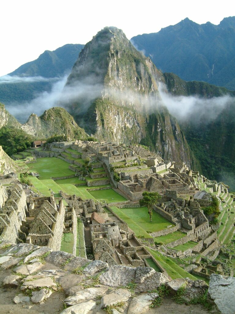 Machu Picchu at sunrise with mist in the valley