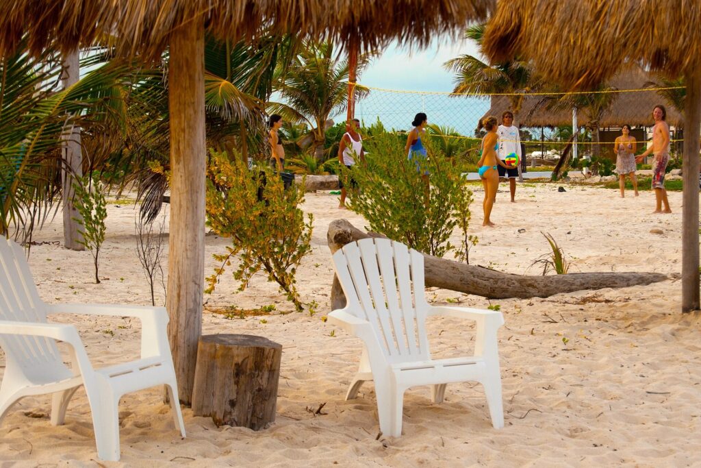 A beach club on the sand at Mahahual, Costa Maya, with palapas and the Caribbean Sea