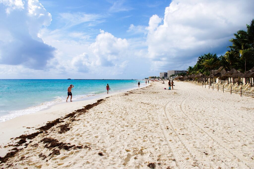 Open beach near Mamitas in Playa del Carmen with soft sand and light surf
