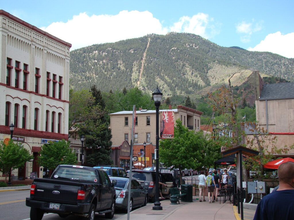 Downtown Manitou Springs, Colorado, with the Manitou Incline's trail visible on the mountainside above town