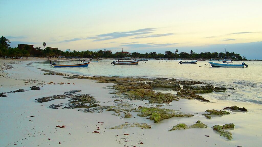 Sunrise over the sand and calm water at Akumal Beach, Mexico
