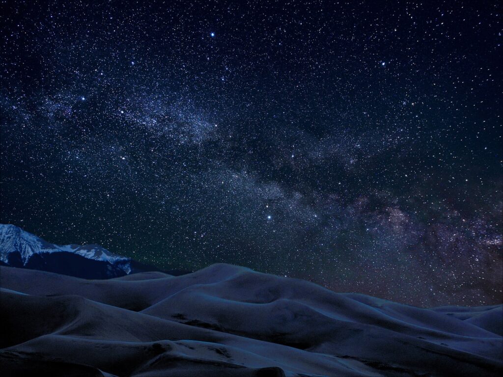 The Milky Way over the dunes at night at Great Sand Dunes National Park
