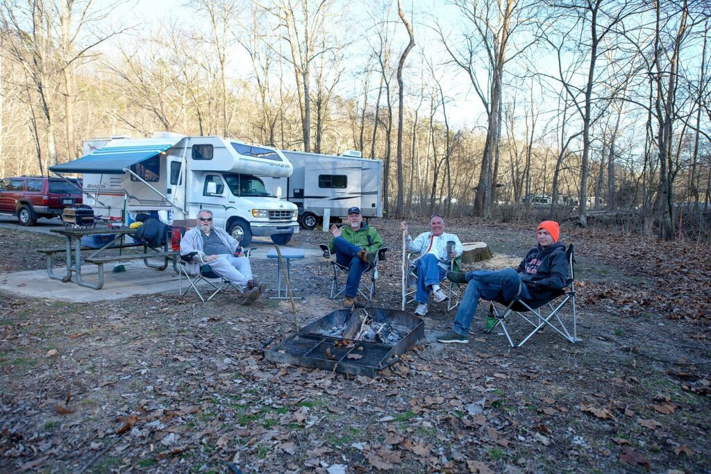 Campers around a campfire at a campsite at Montauk State Park