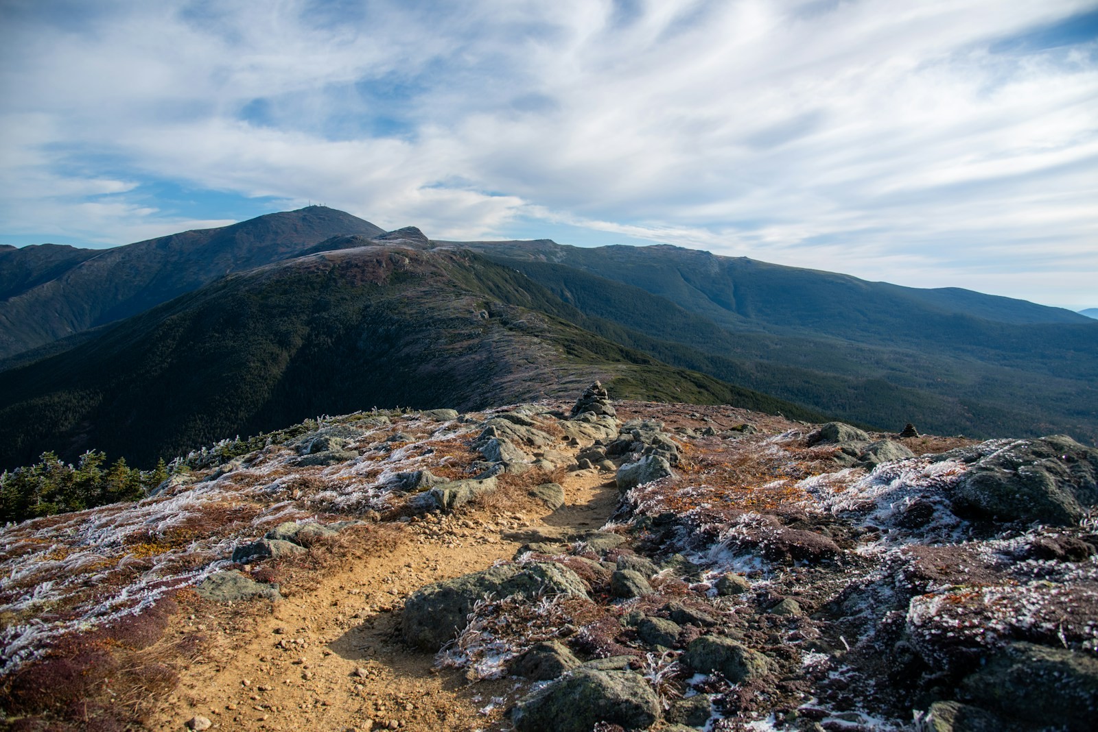 A mountain slope with a trail running through it.