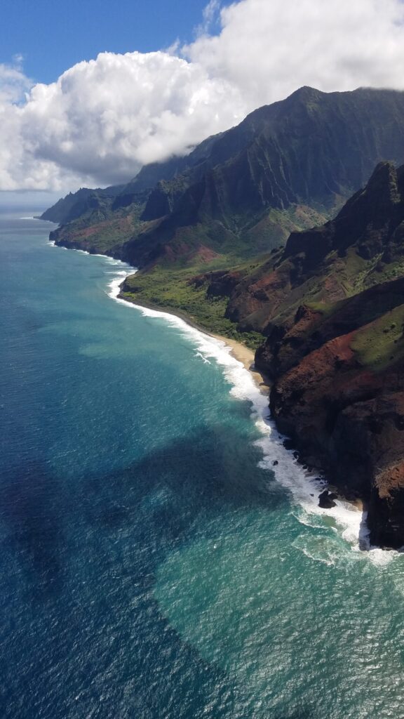 Na Pali Coast from the air, with surf lines along the cliffs