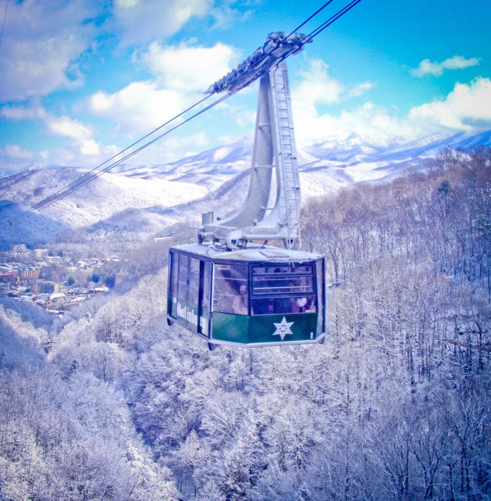 The aerial tramway to Ober Mountain crossing snow-covered ridges above Gatlinburg