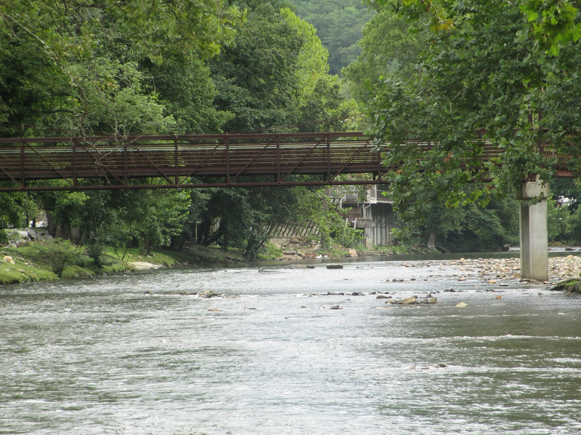 The Oconaluftee River running through downtown Cherokee, North Carolina, seen from the pedestrian bridge