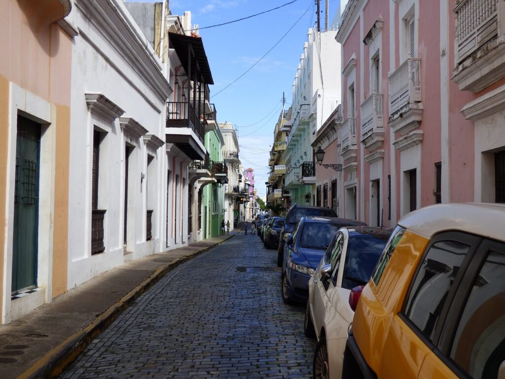 A cobblestone street lined with colorful colonial buildings in Old San Juan
