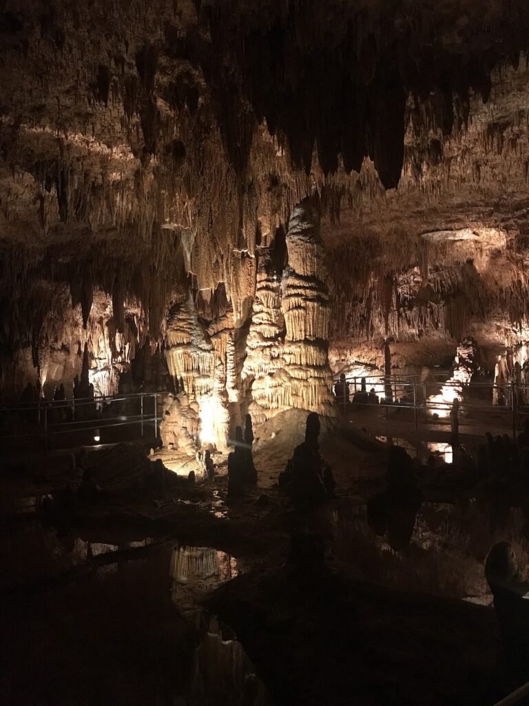 Illuminated stalagmite and stalactite formations inside Onondaga Cave in Missouri