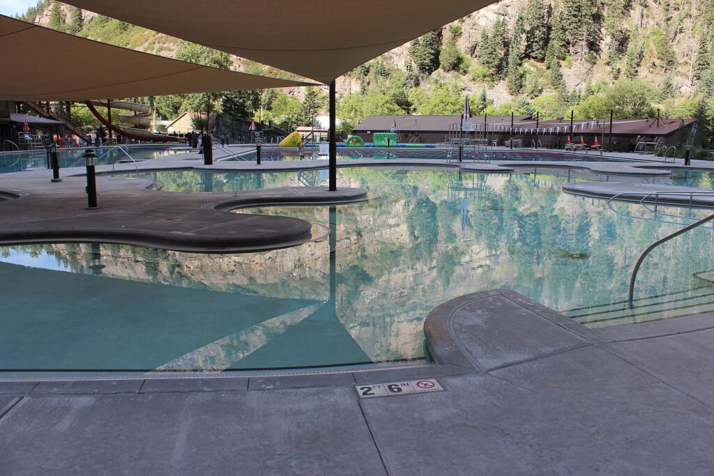 Ouray Hot Springs Pool in Ouray, Colorado, with mountains rising behind the pool