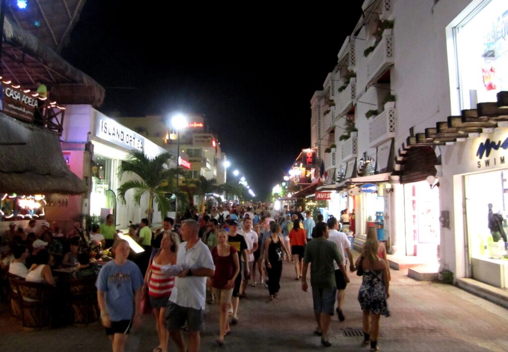 Quinta Avenida, the pedestrian shopping and restaurant street in Playa del Carmen, lit up at night