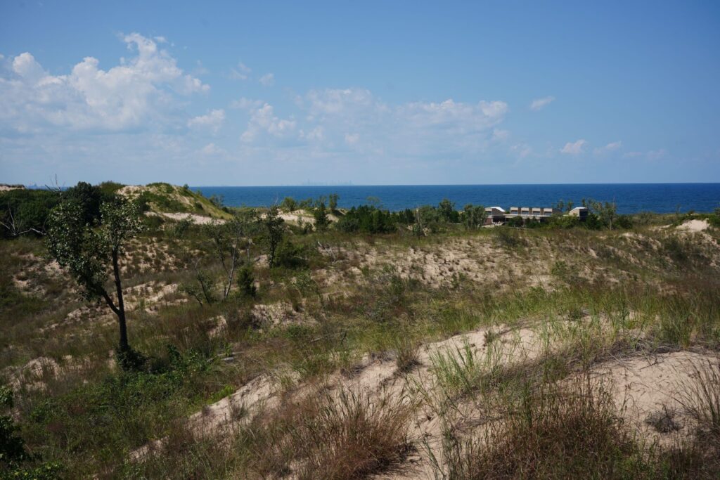 Sand dunes overlooking Lake Michigan under a clear blue sky