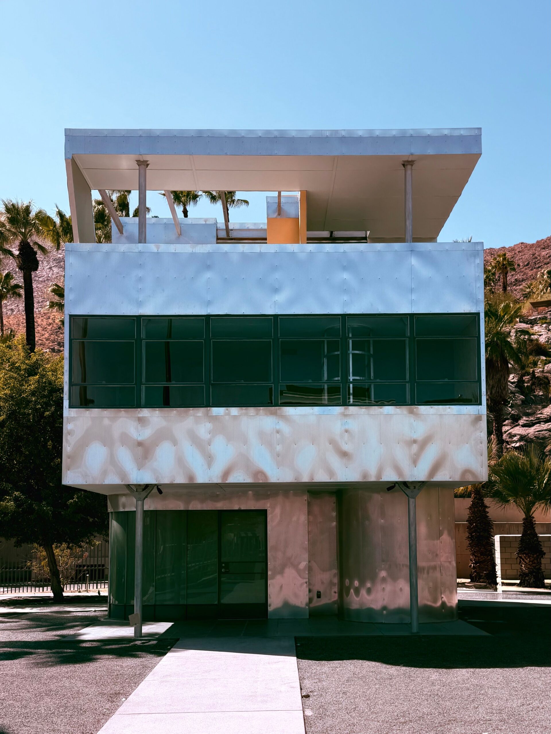 A sleek modern building with reflective glass in downtown Palm Springs