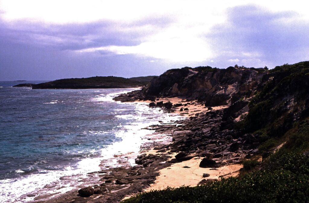 Rocky ocean-side shoreline with small waves on Stocking Island near Great Exuma