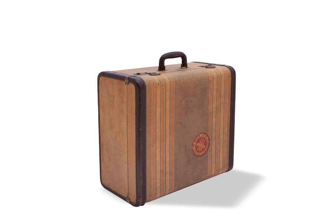 A striped vintage-style suitcase standing upright
