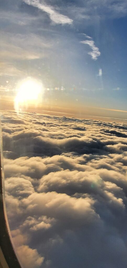 Sunrise above the clouds from an airplane window