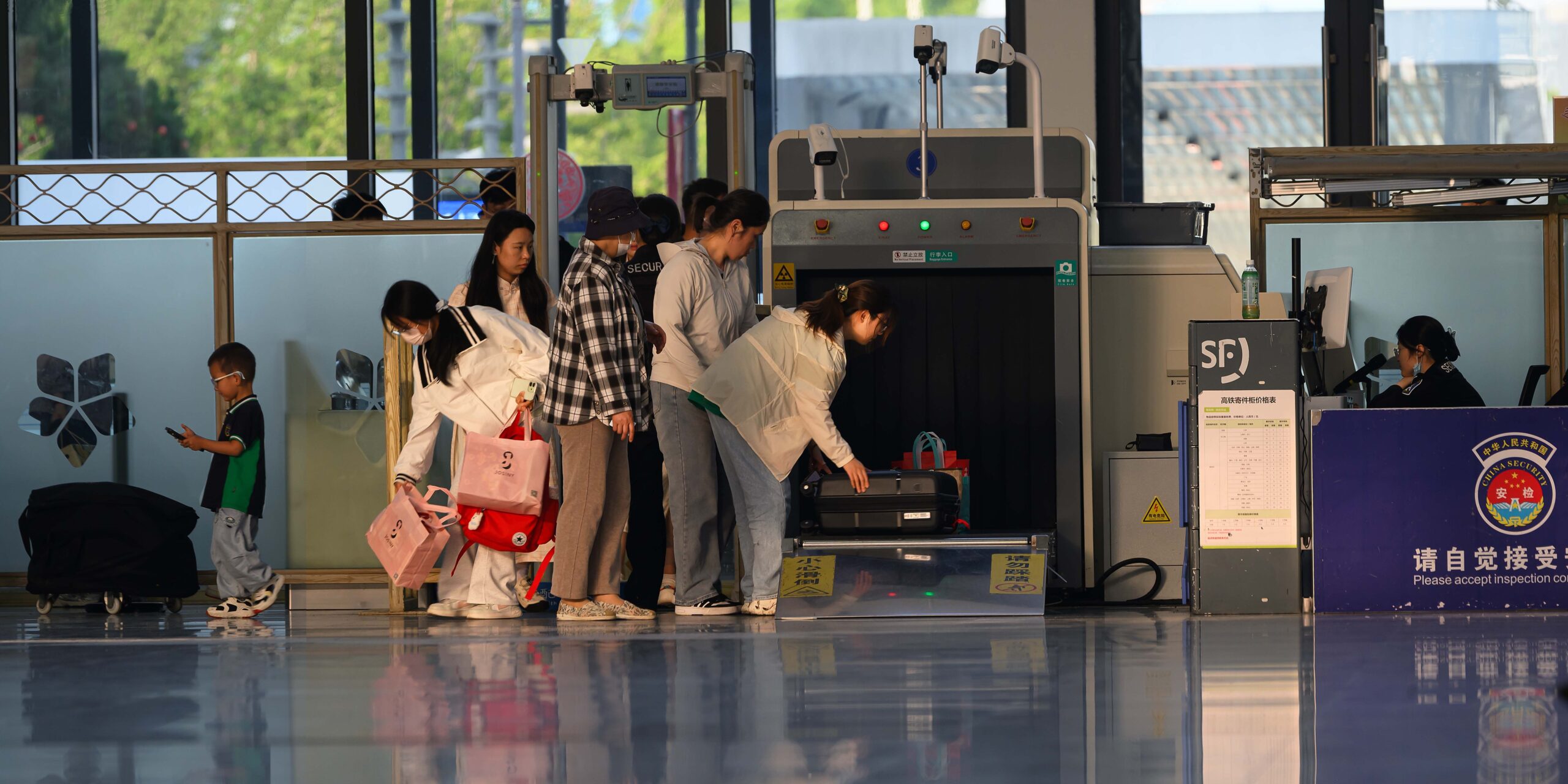 Travelers move through an airport security screening checkpoint