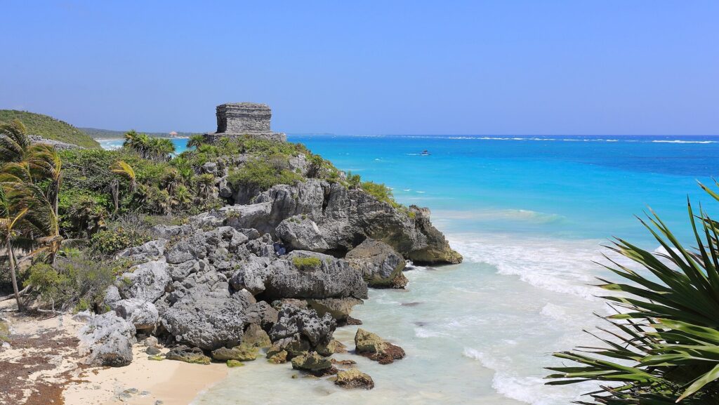 The Temple of the Wind God, a small stone structure at the Tulum ruins overlooking the water