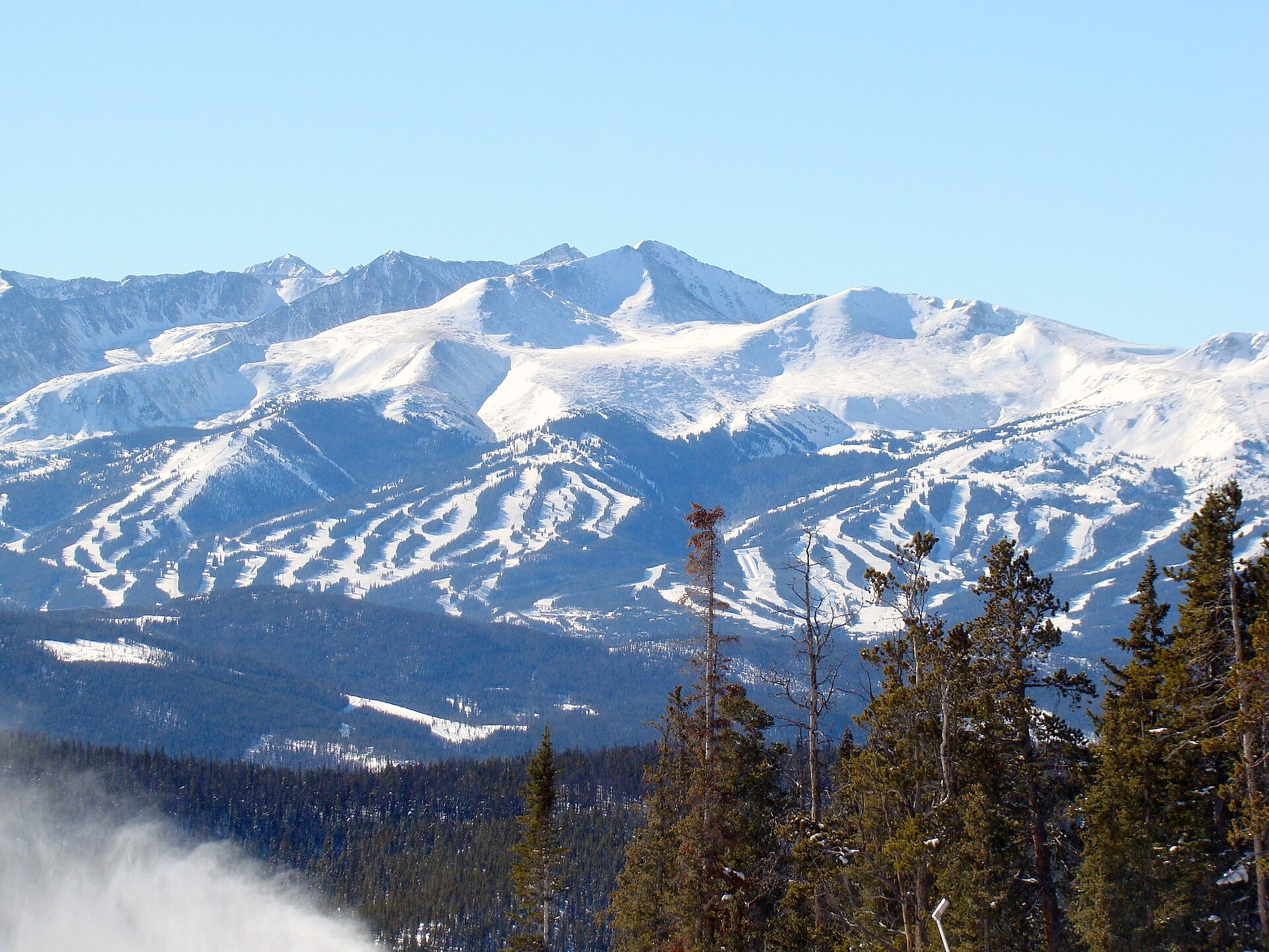 Snowy peaks seen from the top of Dercum Mountain at Keystone Resort, Colorado, with Breckenridge's ski runs in the distance
